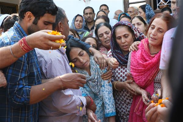 Family of Puran Krishan Bhat mourning