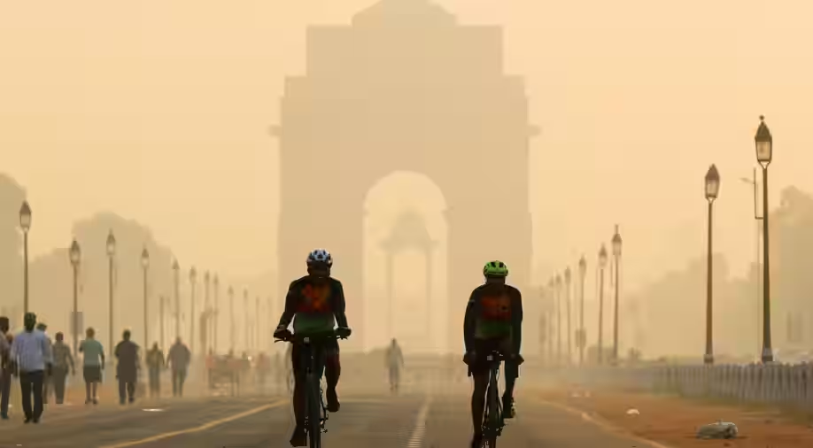 Cyclists With Delhi's Smog As Backdrop